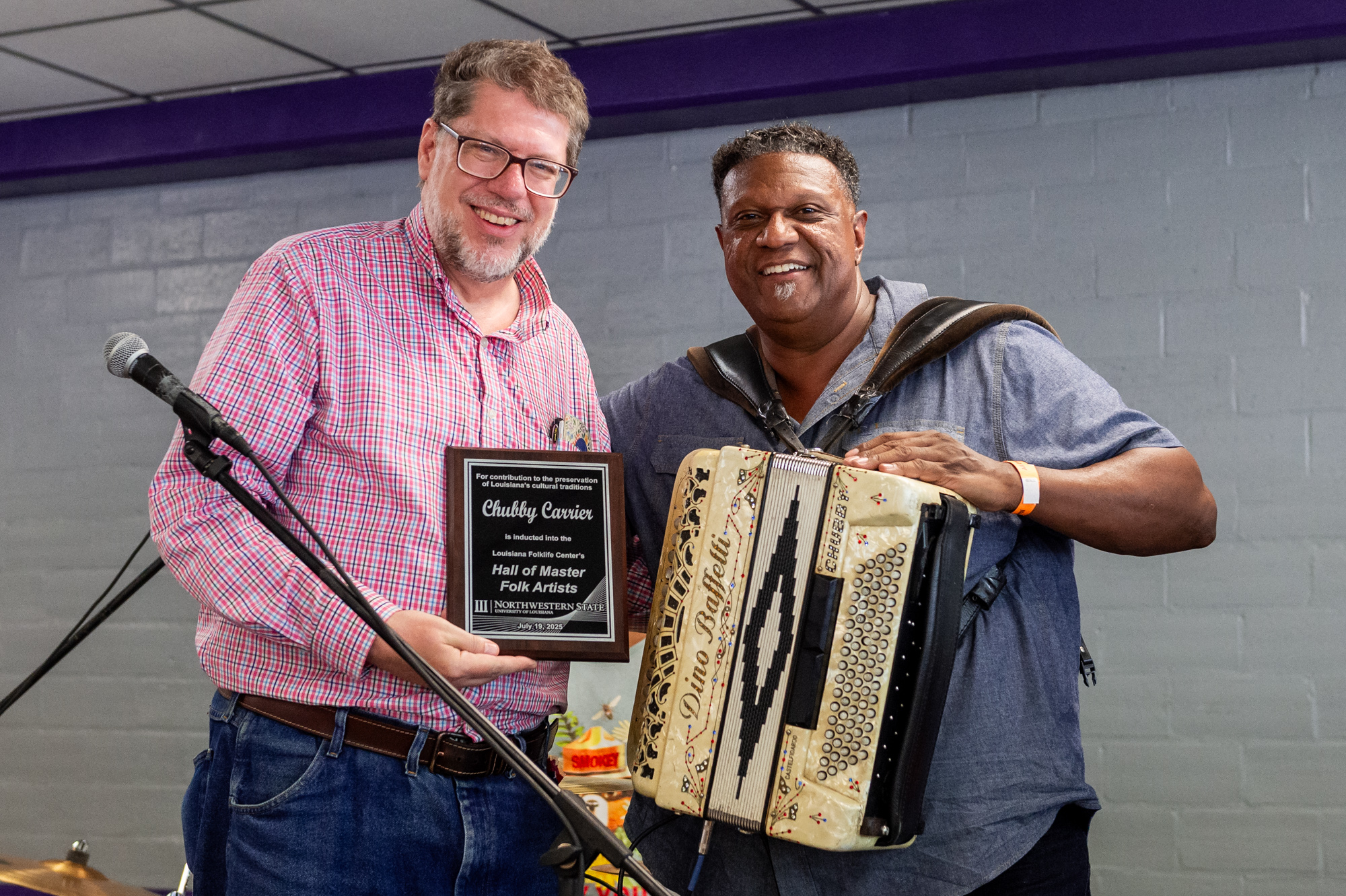 2025 Hall of Master Folk Artists inductee Chubby Carrier, right, with Folk Festival Director Dr. Shane Rasmussen.