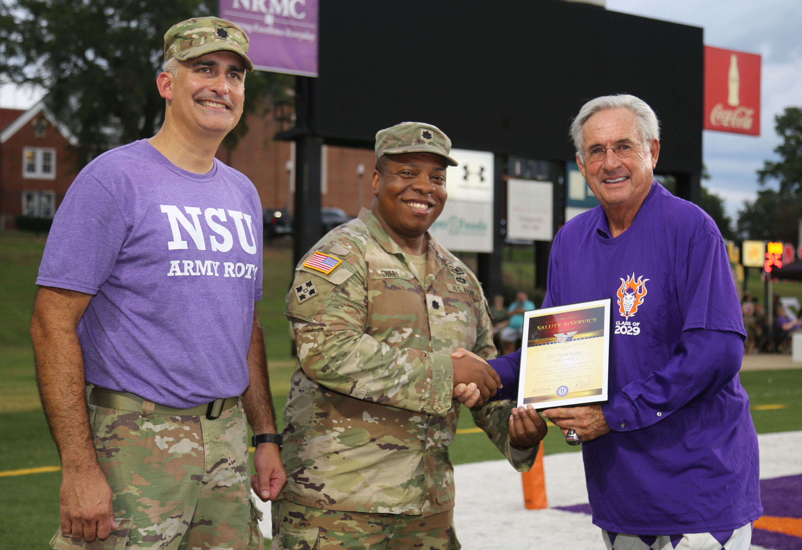 Lieutenant Colonel Tyrek Swaby was the honorary captain of the NSU’s season opening football game Aug. 28. From left are LTC Josh Drake, Swaby and NSU President James Genovese.